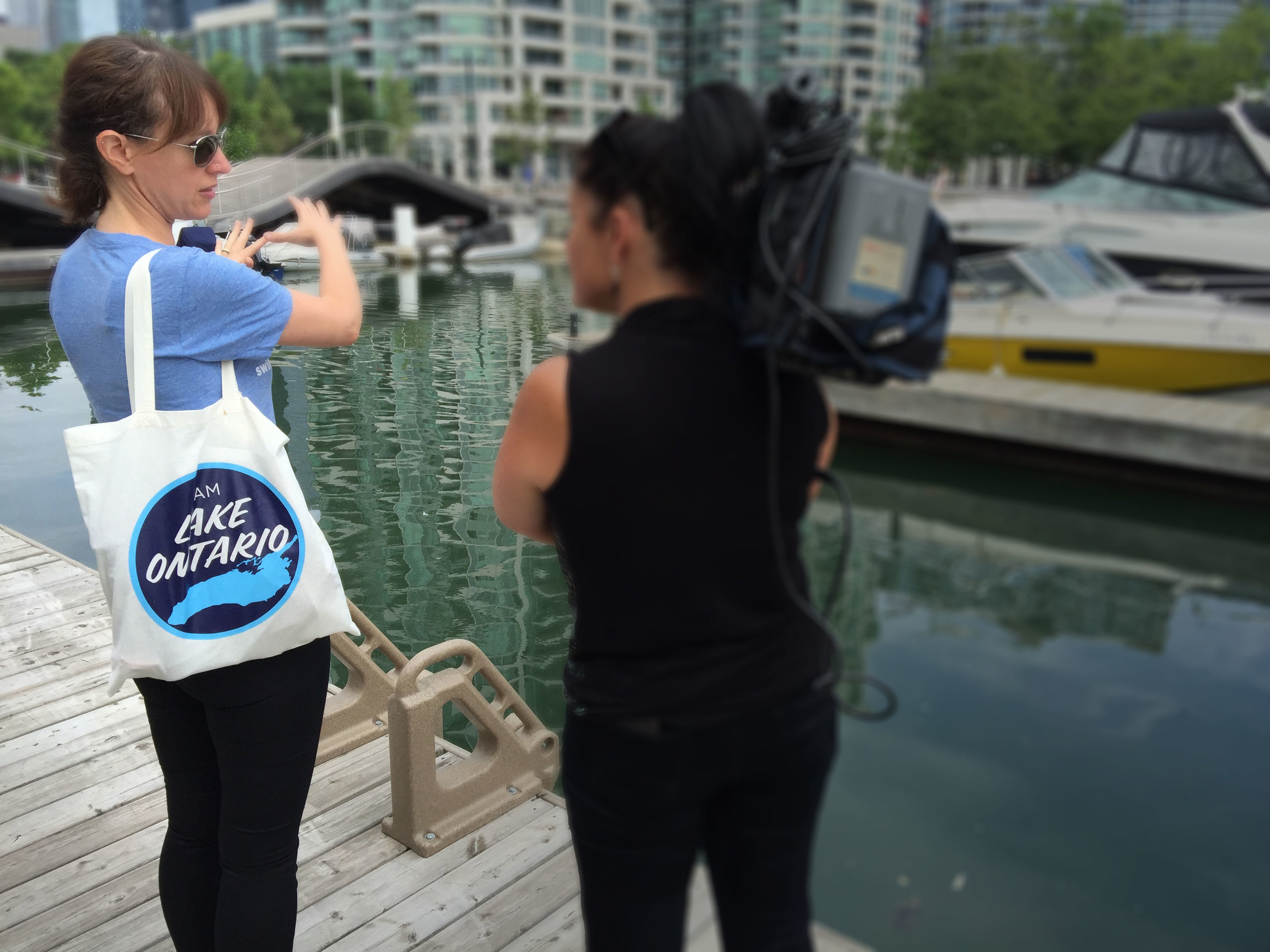 Waterkeeper Vice-President, Krystyn Tully talks to CityTV about the sewage pollution found in Toronto's inner harbour. (Photo by Lake Ontario)..