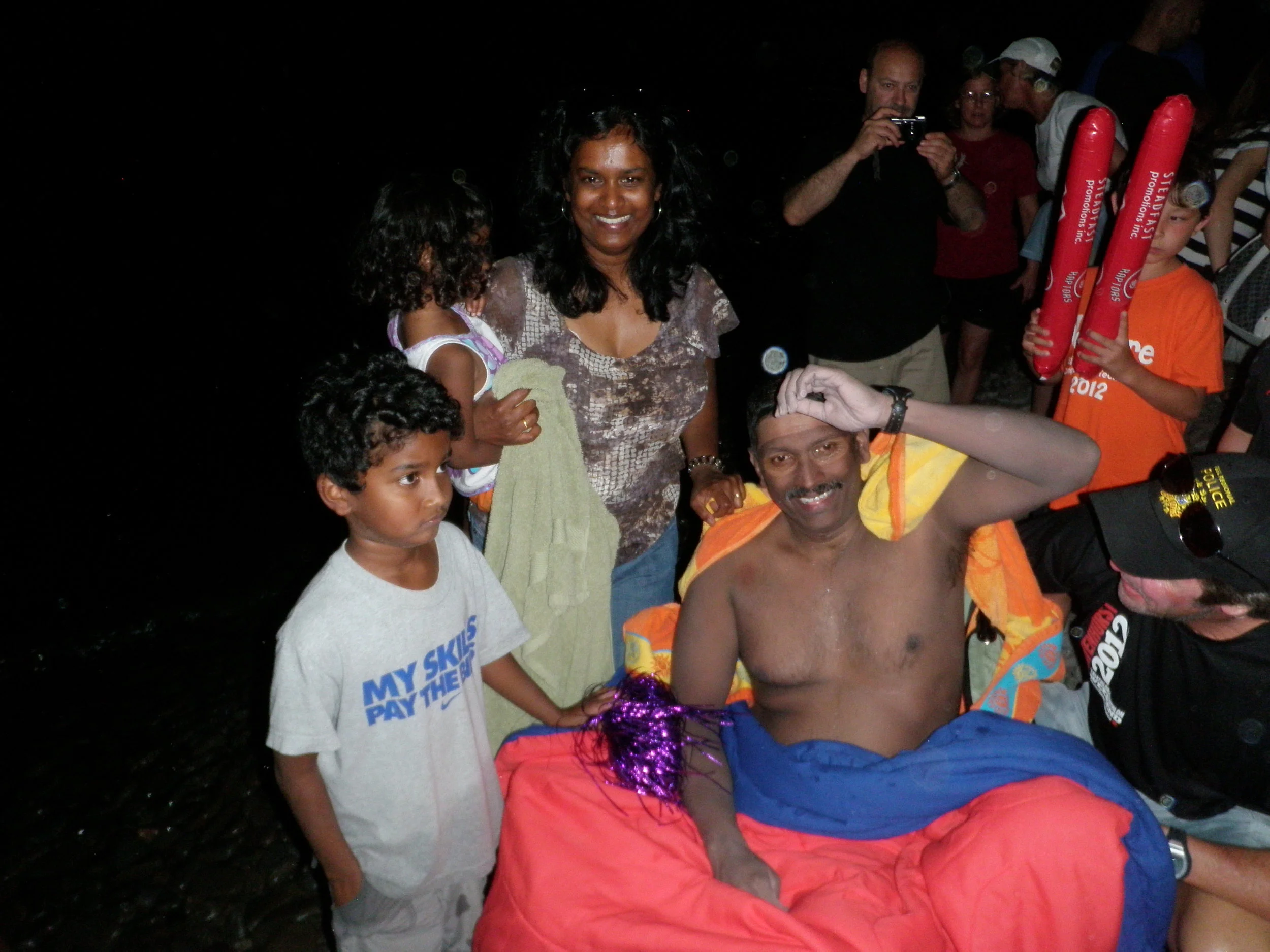 Madhu with his family after his epic swim across Lake Ontario. (Photo via L.O.S.T. Swimming )