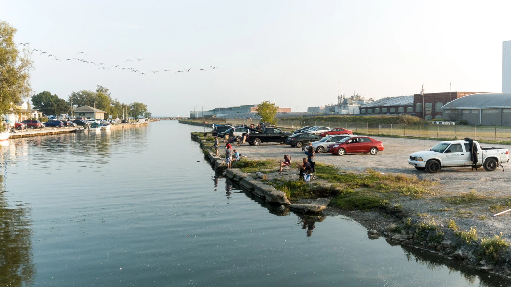 Community members fishing at the mouth of the Gananaska River, next to Cameco's Conversion Facility. (Photo by Dylan Neild)