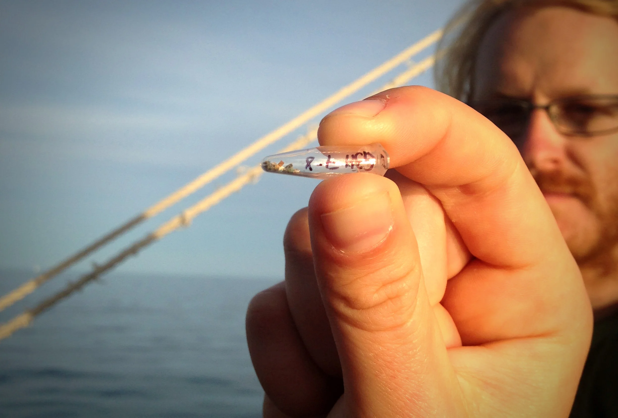 Taking a close look at microplastics skimmed from Lake Ontario, south of Humber Bay with Ontario Streams. (Photo by Gabrielle Parent-Doliner)