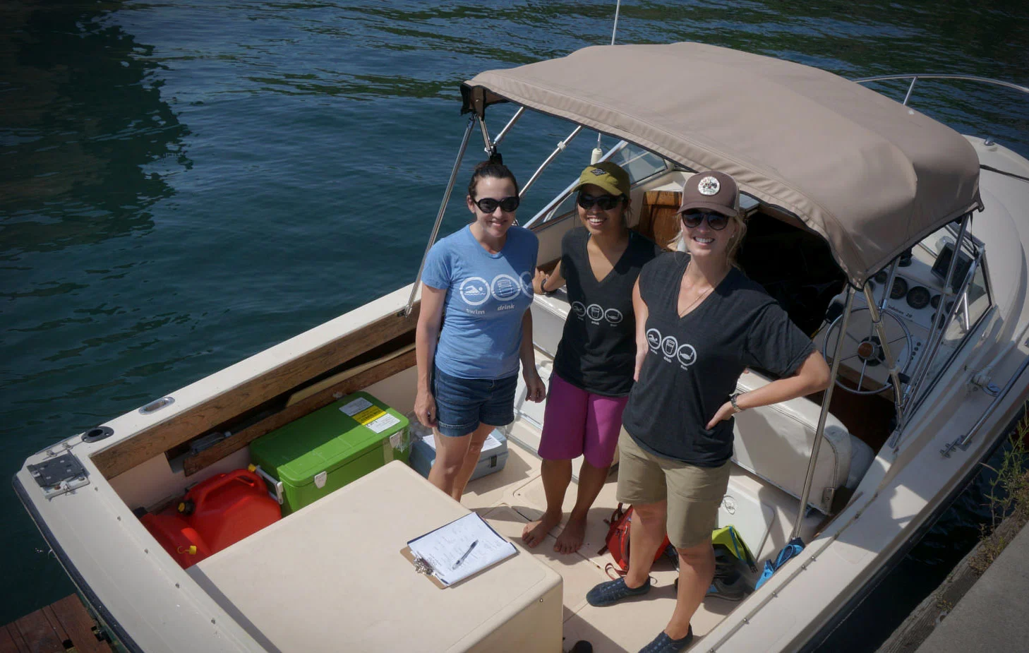 Waterkeeper's team wearing their Swim Drink Fish circles with pride while collecting water samples from Toronto's harbour this past summer. (Photo by Li Black)