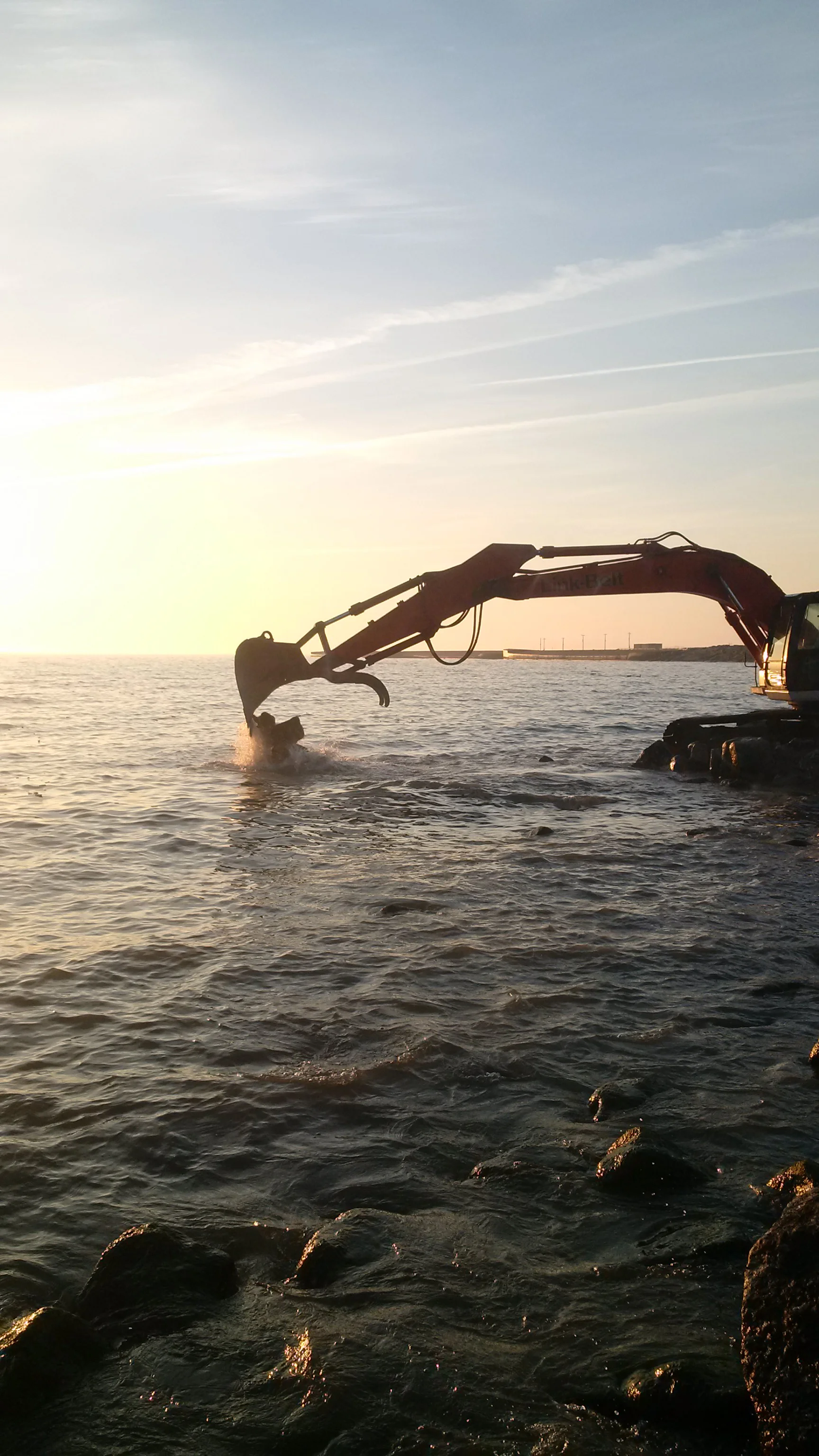 The first load of rubble is placed for the new waterfront conservation area.