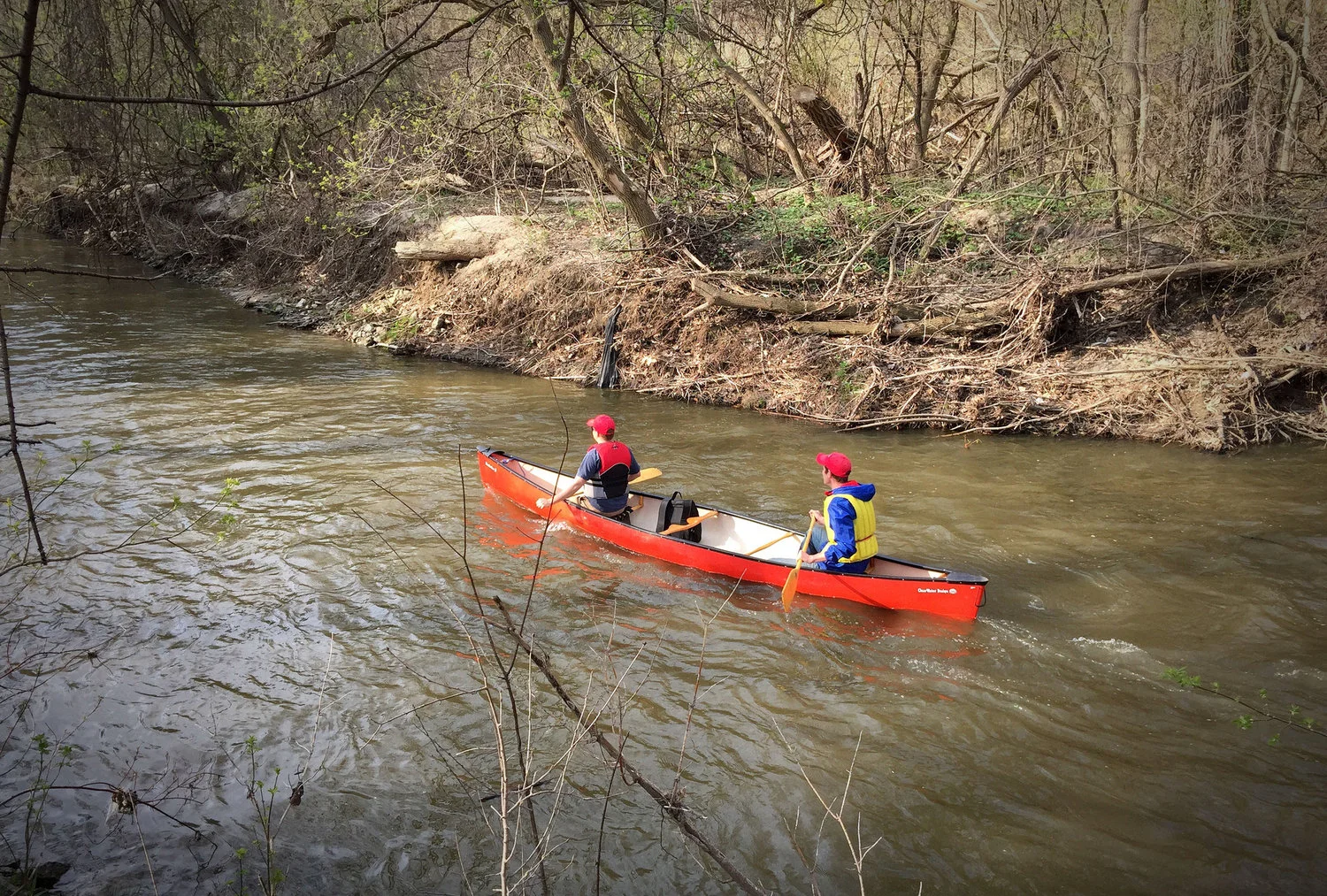 Two participants paddling along the Don River in Manulife's annual Paddle The Don. (Photo by Ruby Pajares)