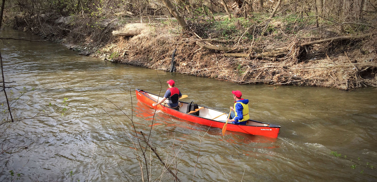Two participants paddling along the Don River in Manulife's annual Paddle The Don. (Photo by Ruby Pajares)