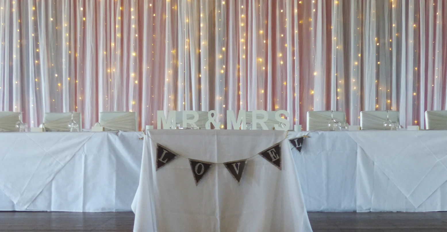 Simple white backdrop with fairy lights.