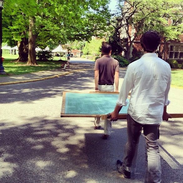 Clay '02 and Andrew'02 hauling the chalkboard for Switchboard Hearts. 