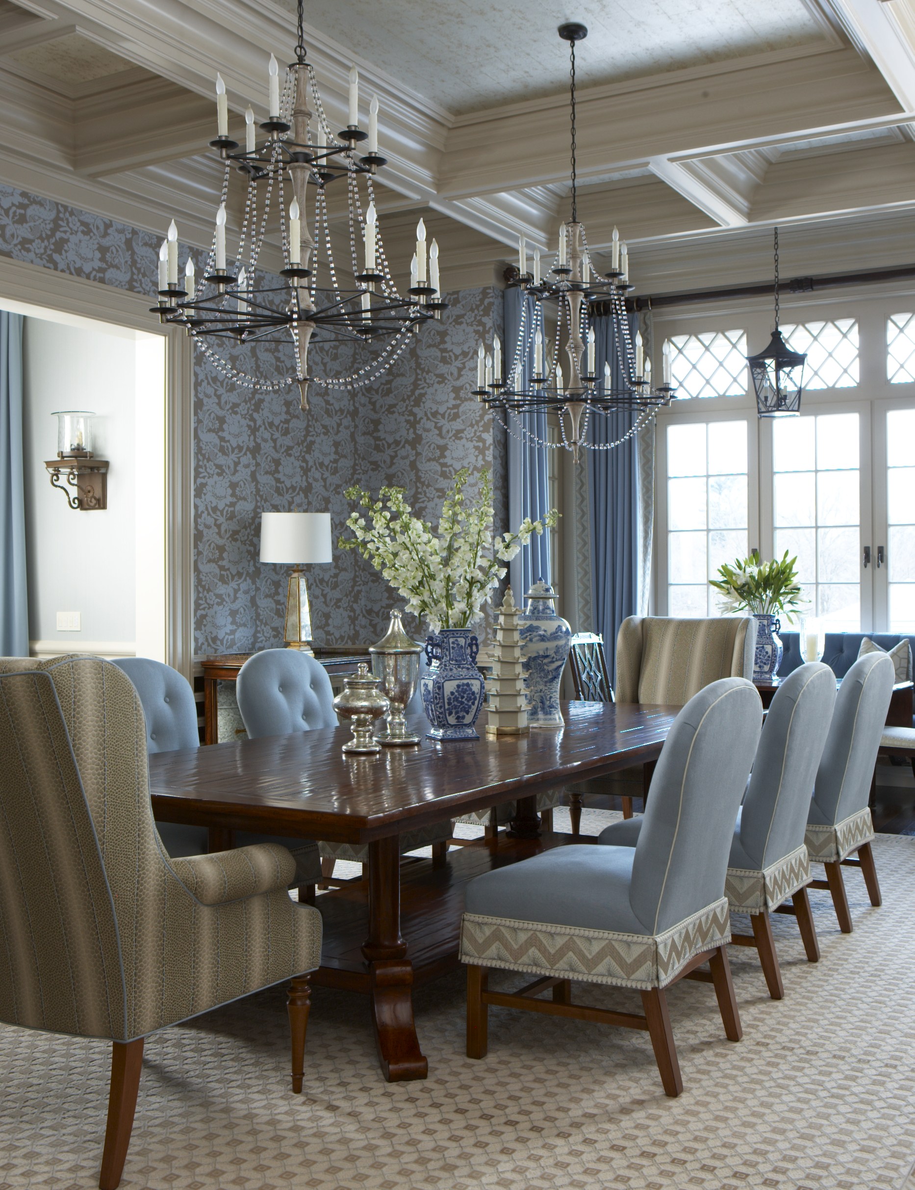Two chandeliers help to fill the grand size of the dining room and are more relaxed than one very dominant light fixture. Photo by Michael Partenio.