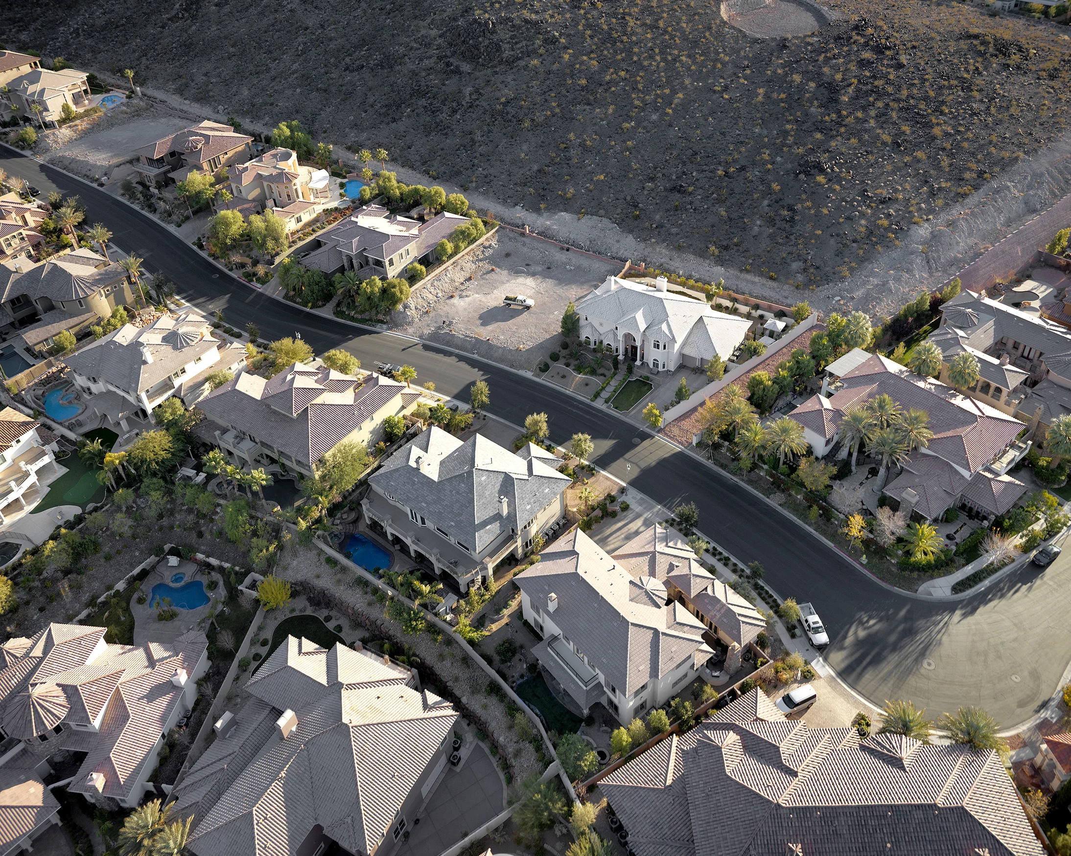 19. “Roma Hills” guard-gated homes looking south over Harpsichord Way; landscaper at work, Henderson, Nevada; 2011