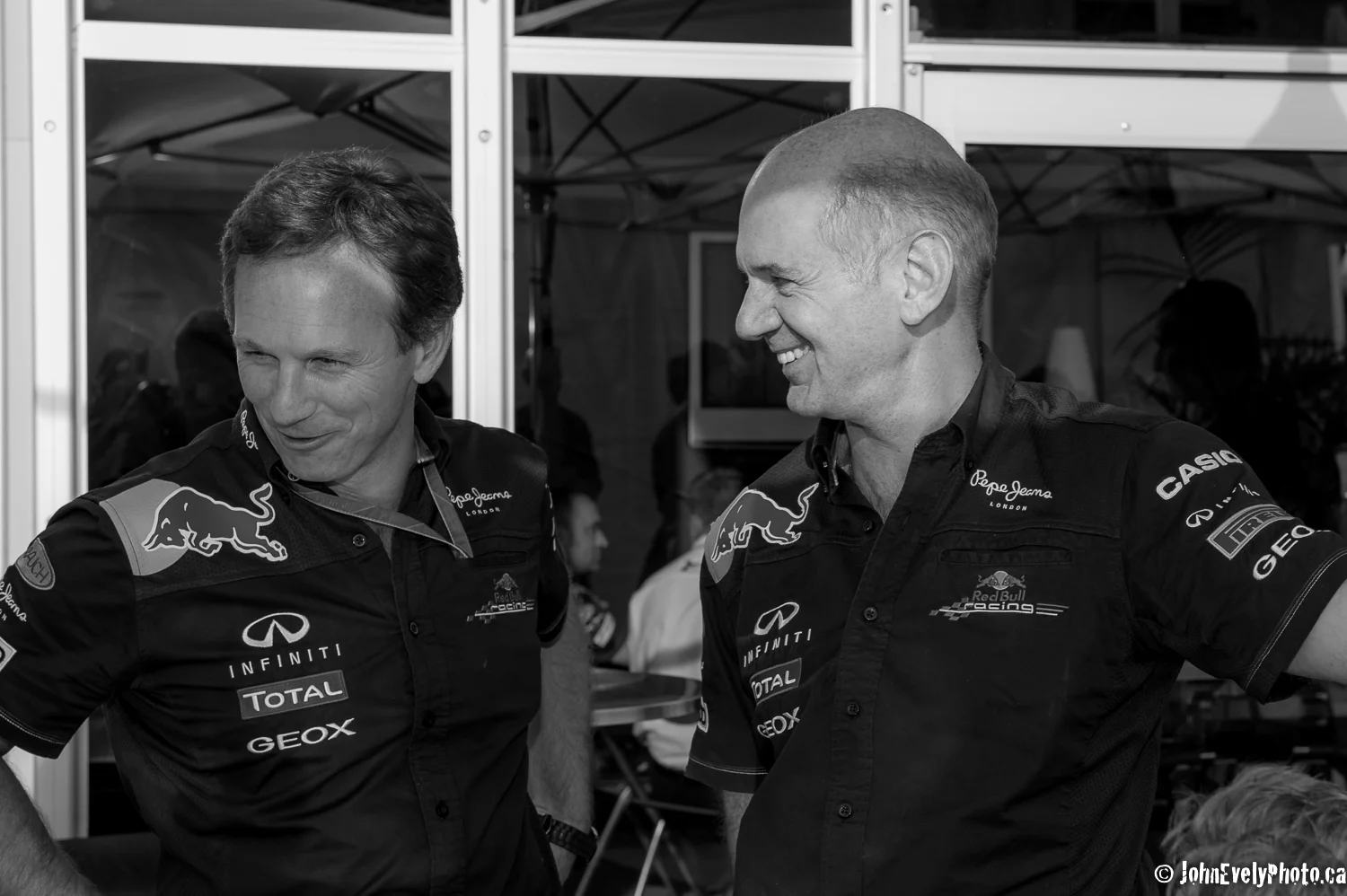 Red Bull Team Principle Chris Horner and Design Guru Adrian Newey smiling in the paddock after Seb Vettel wins pole postion in qualifying.