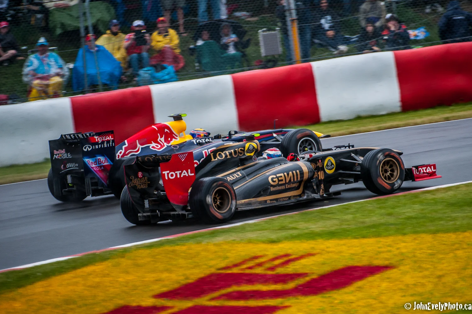Red Bull and Lotus battle for position exiting turn two in Montreal.