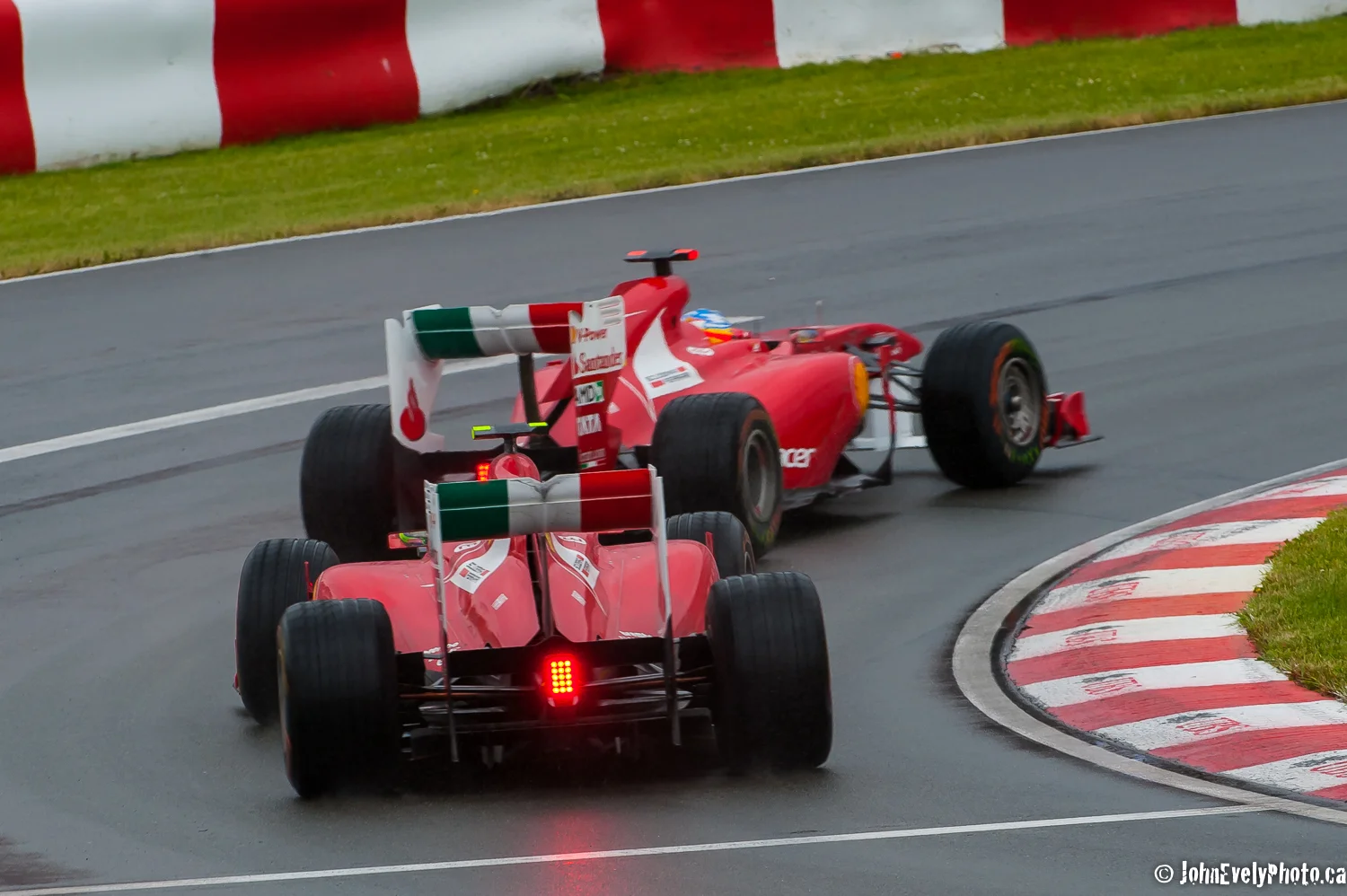 Felipe Massa's Ferrari follows Fernando Alonso's exiting turn two in Montreal.
