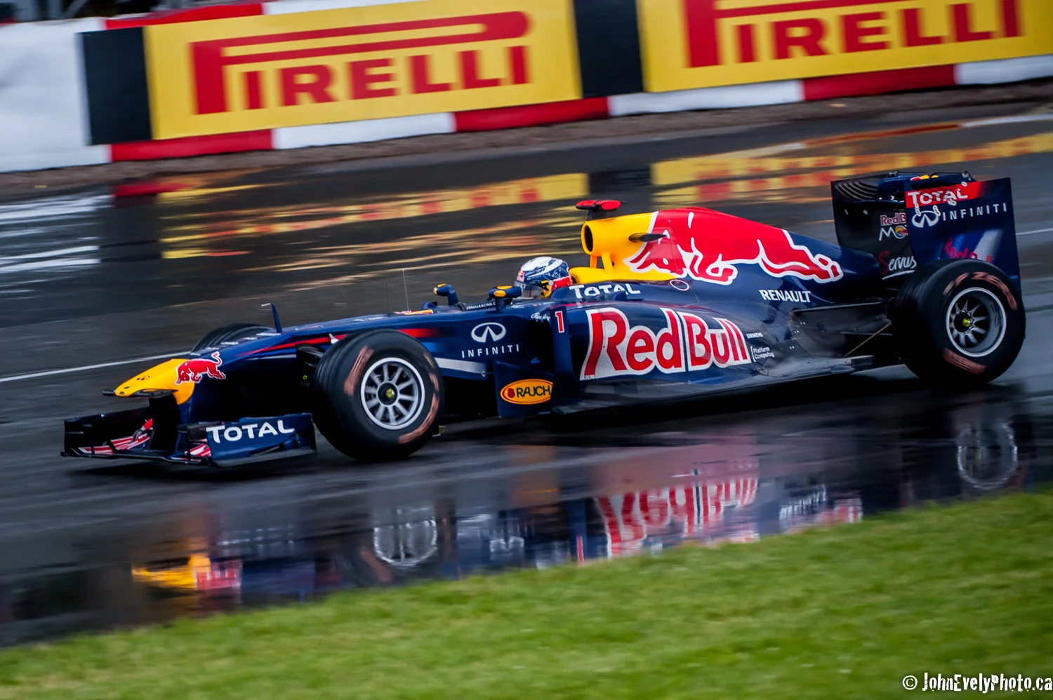 Sebastien Vettel turn one in the rain.
