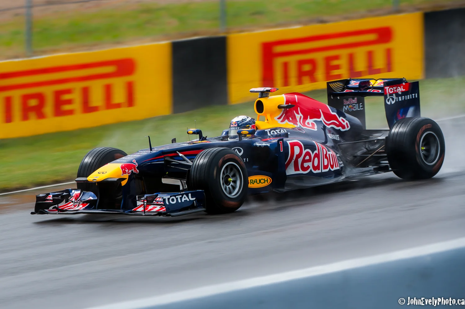 Sebastien Vettel racing in the rain. I hope you've been briefly entertained by these F1 pics! Send me a comment! John E