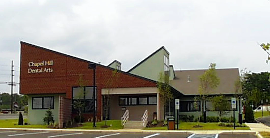   Chapel Hill Dental Arts |  Is a full service dental facility with patient areas and areas devoted to the manufacturing of porcelain prosthetics.&nbsp; The building sits on an extremely busy state highway.&nbsp; The design successfully shields the h