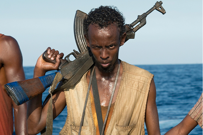 PHOTO CREDIT: Above is a production still from Captain Phillips featuring actor Barkhad Abdi as Muse, the leader of the Somali pirates.