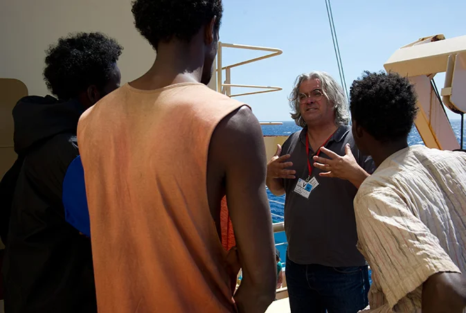 PHOTO CREDIT: Above photo (from here) features director Paul Greengrass on the set of Captain Phillips with Barkhad Abdi&nbsp;and other actors.