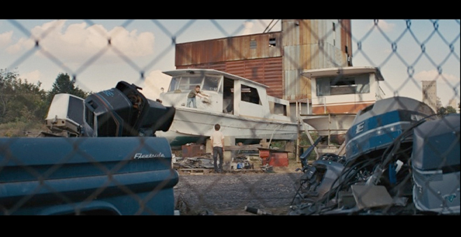 PHOTO CREDIT: Above is a screenshot of Ellis and Neckbone at the junkyard gathering materials to help Mud getaway.