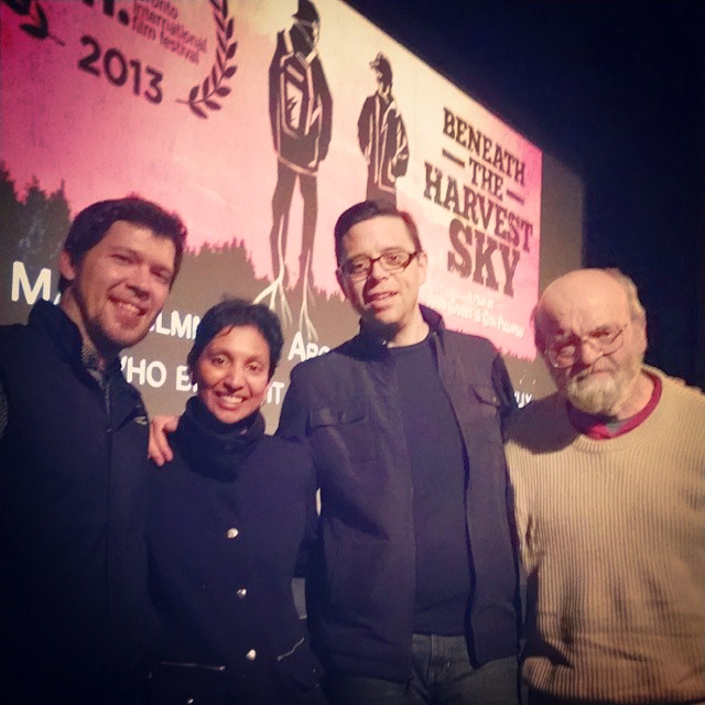 The cast and directors of Beneath The Harvest Sky , from left to right: Scott Anthony Smith, Gita Pullapilly & Aron Gaudet (Directors) and Peter Paton - in front of The Strand Theater, Rockland, Maine . (Image via Scott Anthony Smith's Facebook .)