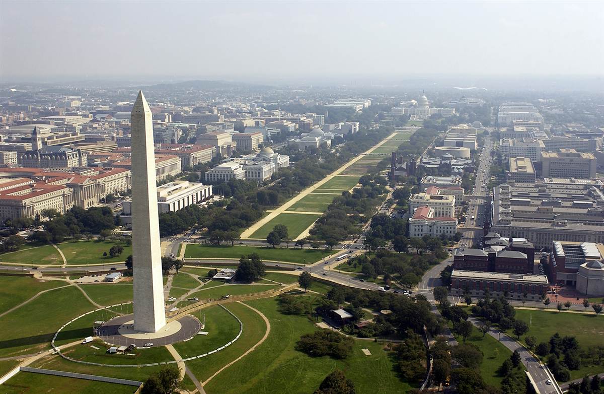 An aerial view of the National Mall flanked on each side by the Washington Monument and the U.S. Capitol - image via Google .