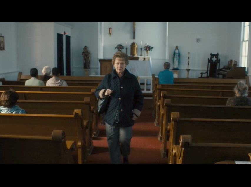 Screenshot: Philomena leaving St. Anthony's Catholic Church. For the movie, the production team added the congressional boxes on both sides of the church's interior.