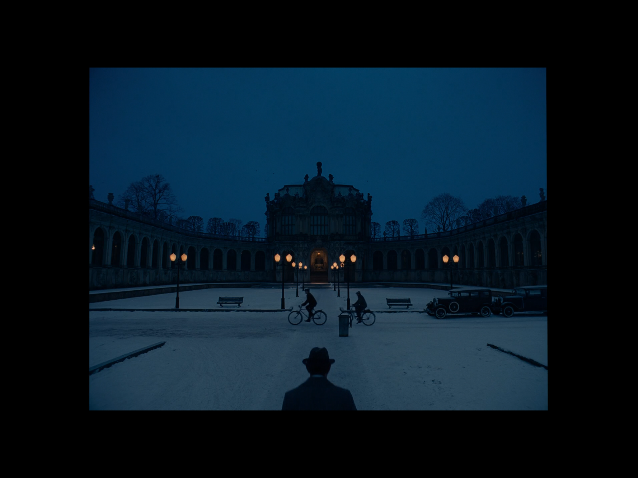 Screenshot of a scene with Deputy Kovak walking toward the Kunstmuseum (filmed at the Zwinger Museum in Dresden, Germany).