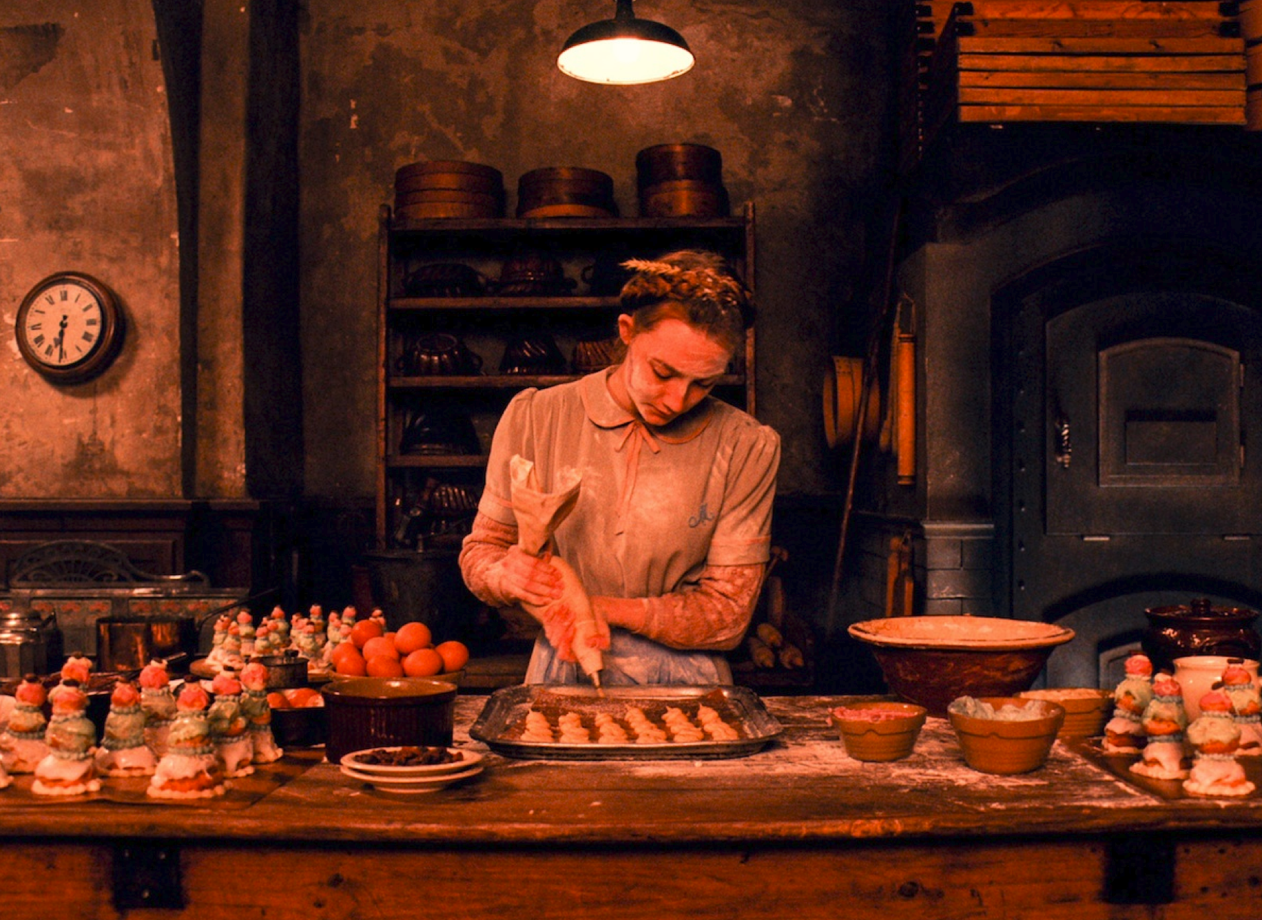 Production still of Agatha putting on the finishing touch on the beautiful pastries of Mendl's&nbsp; - image via Google.