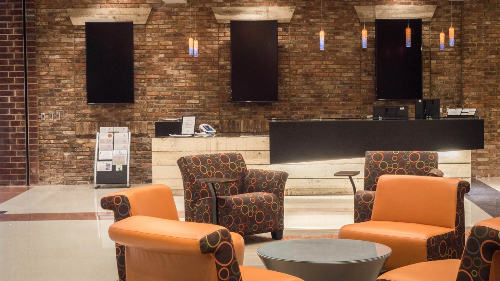 The reception desk in the main lobby is made from reclaimed wood and brick from the former Bassett Furniture Superior Lines factory.