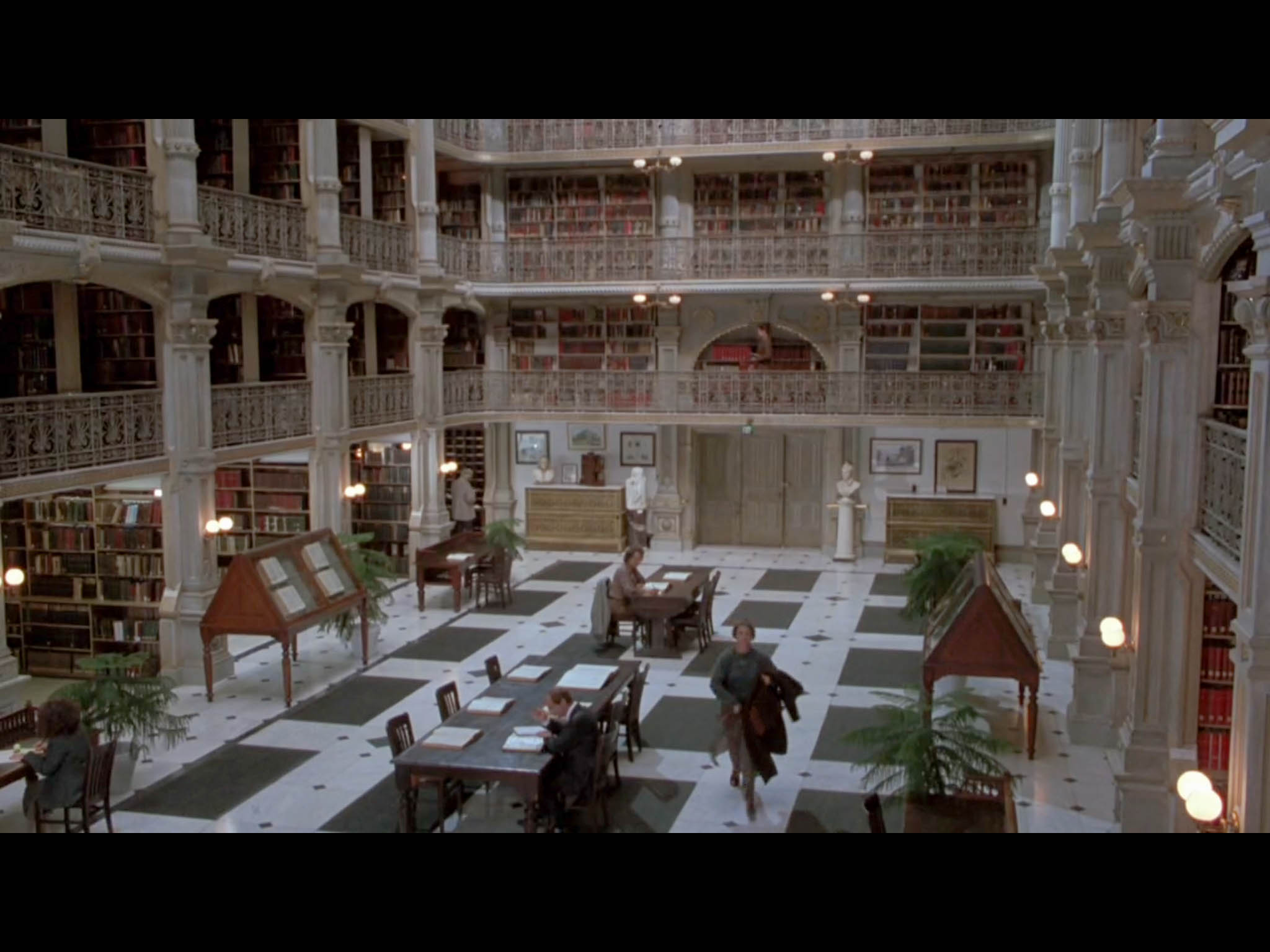 Screenshot from Sleepless In Seattle of Annie walking through her brother's office building - filmed on location at the George Peabody Library.