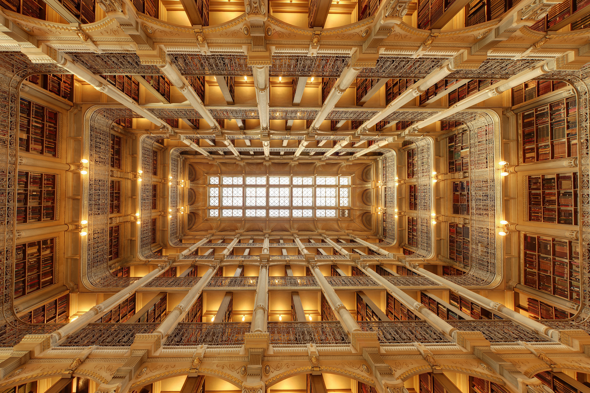 The stunning five tears of ornamental cast-iron balconies of the George Peabody Library rising 61 feet to a glass skylight ceiling above. Photo by Matthew Petroff .