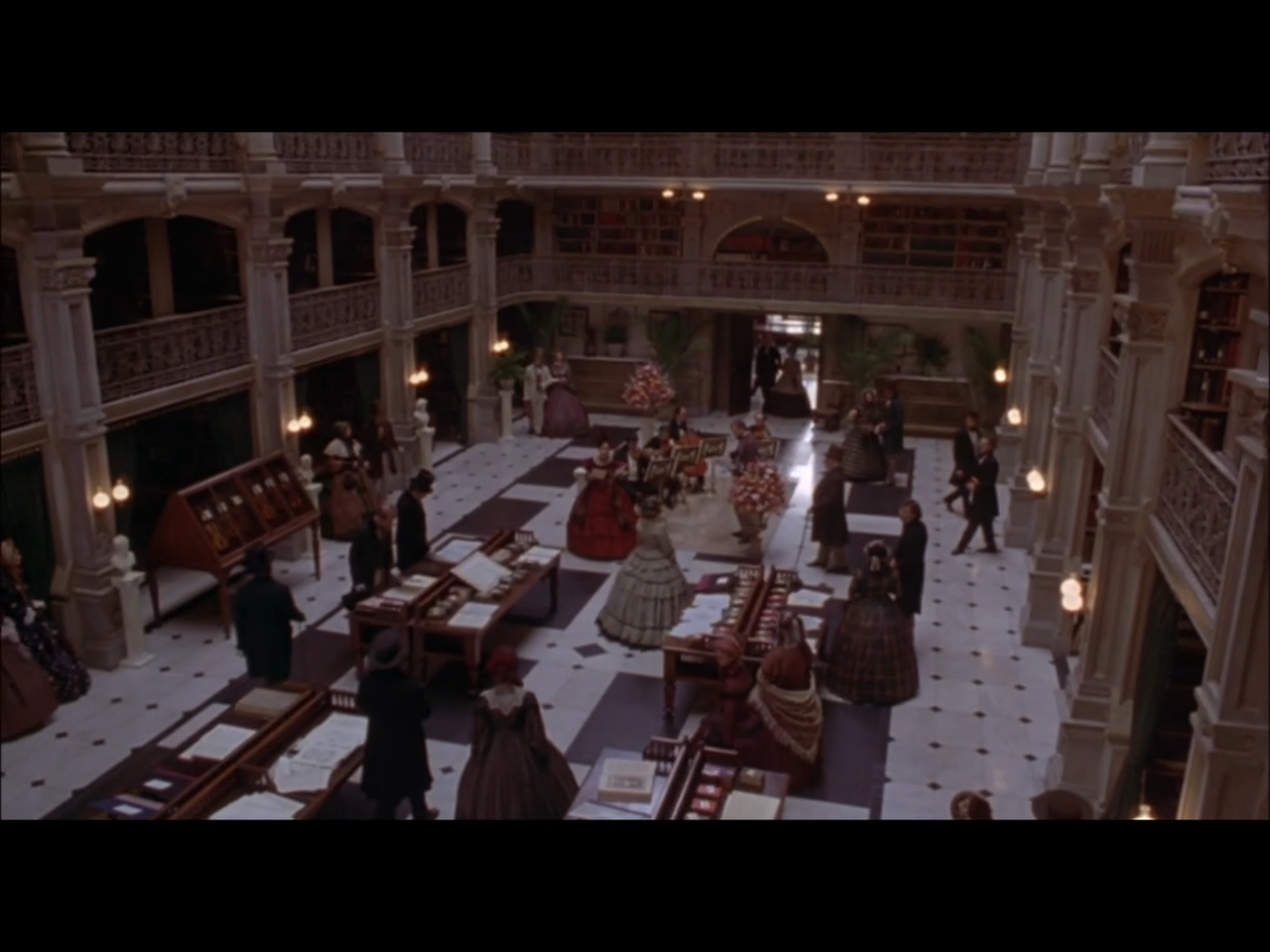 Screenshot from Washington Square of a Paris bookshop scene filmed on location at the main reading room of the George Peabody Library.