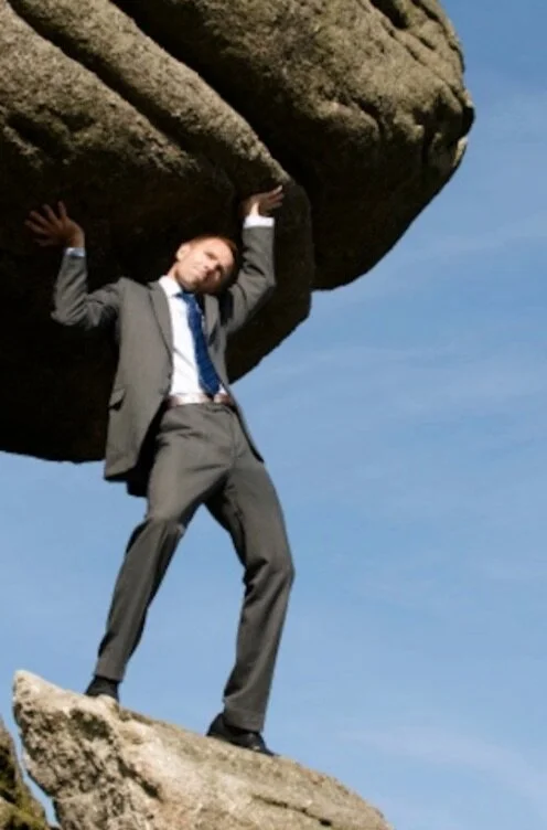 man holding up huge rock.jpg