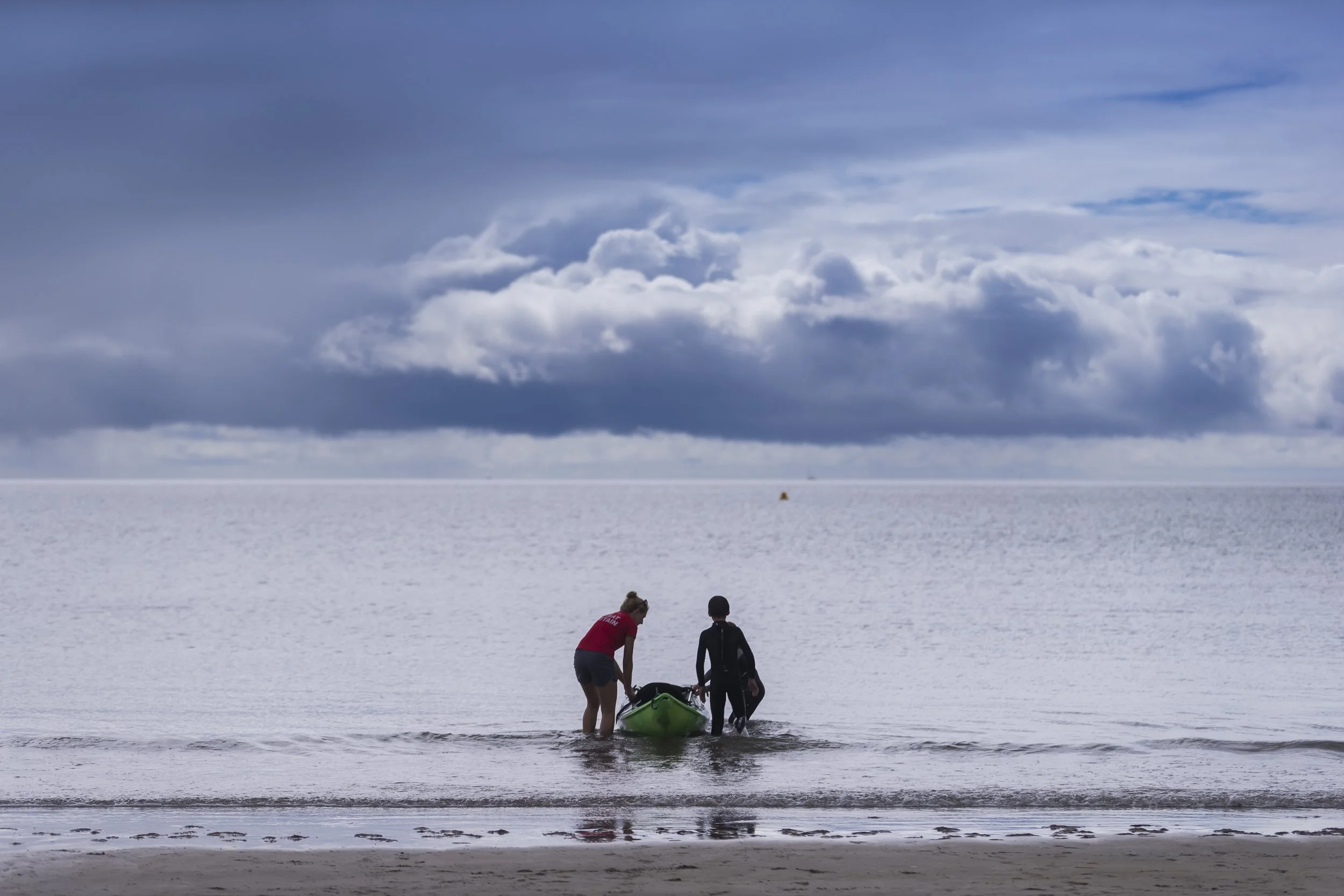 South east brand and reportage photographer, seascape,  with two people and canoe,