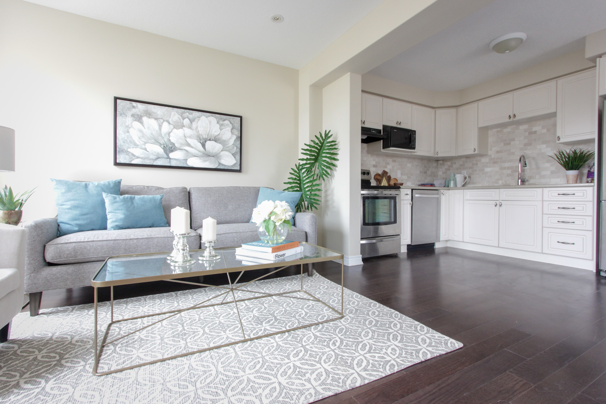 Home Staging provided by New Leaf Decor of living room - neutral furniture with pops of colour add appeal