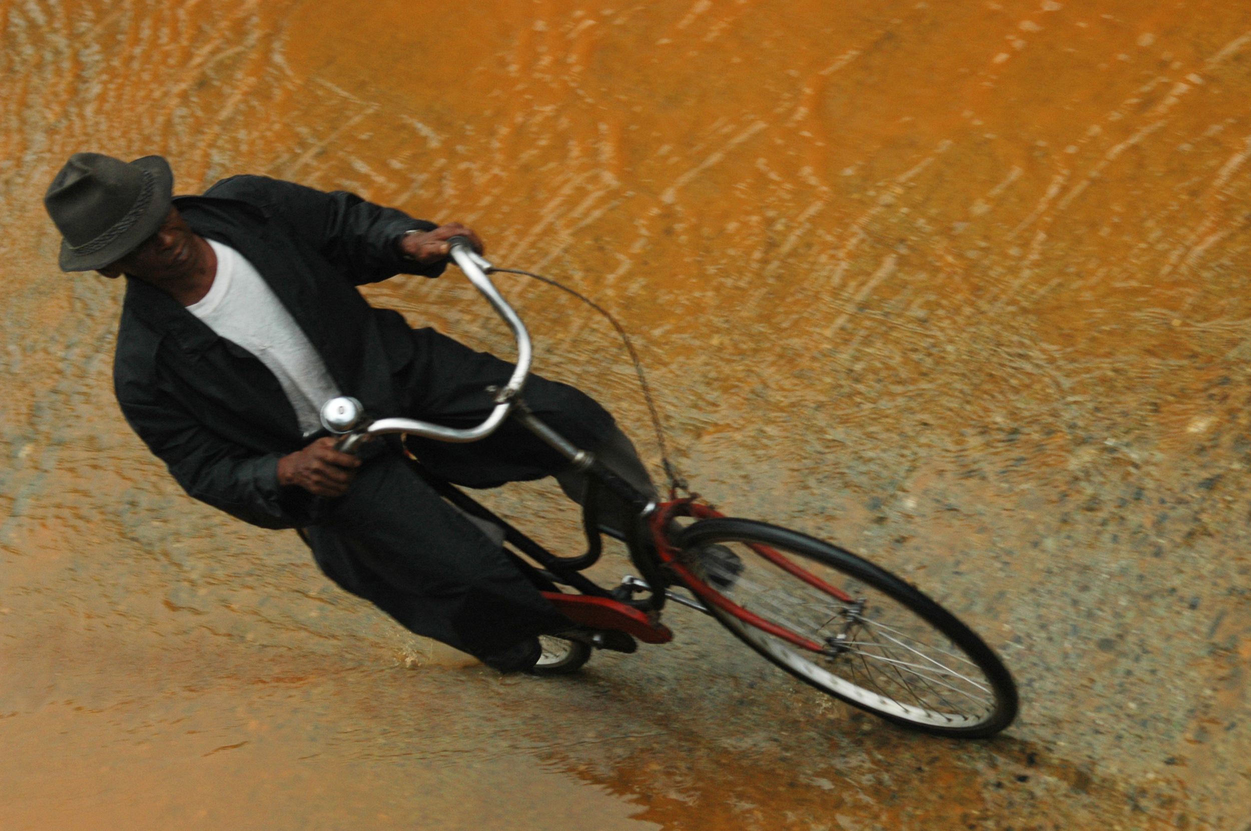A man makes his way through washed out street after heavy rains in Baracoa, Cuba.
