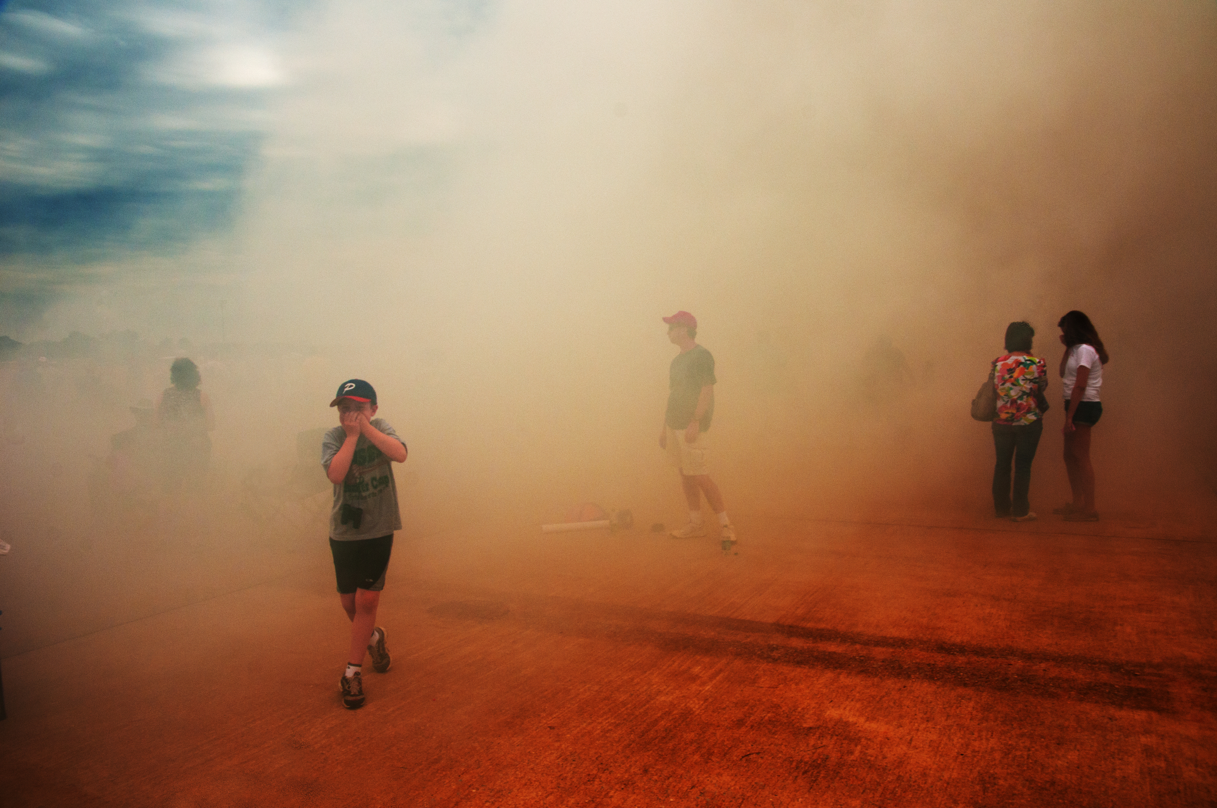 A boy evades rocket car exhaust during Joint Services Open House and Air Show at Joint Base Andrews, Camp Springs, MD. 