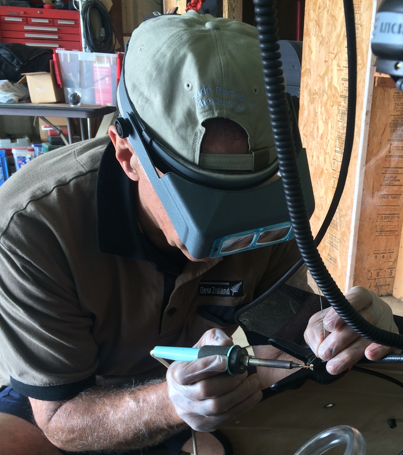 Manouch solders a wire during the radio installation.