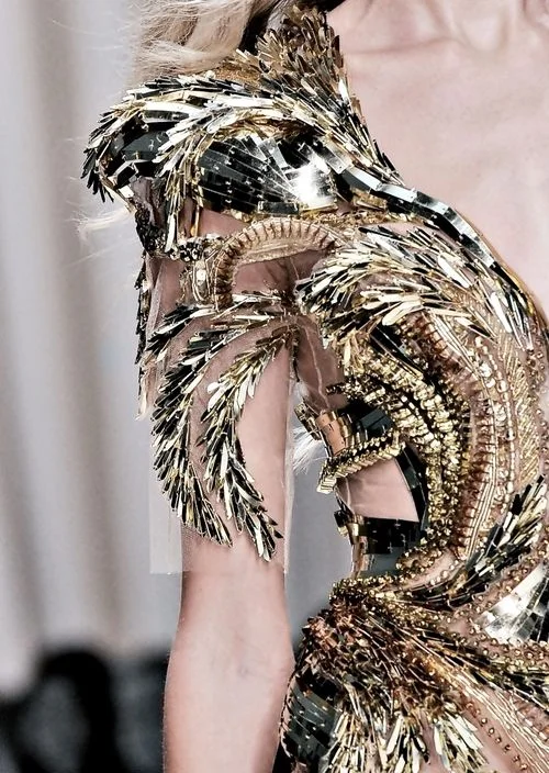 Fashion Gold... luxurious gold dress with an intricately structured, raised pattern; closeup couture; opulent fashion Valentin Yudashkin