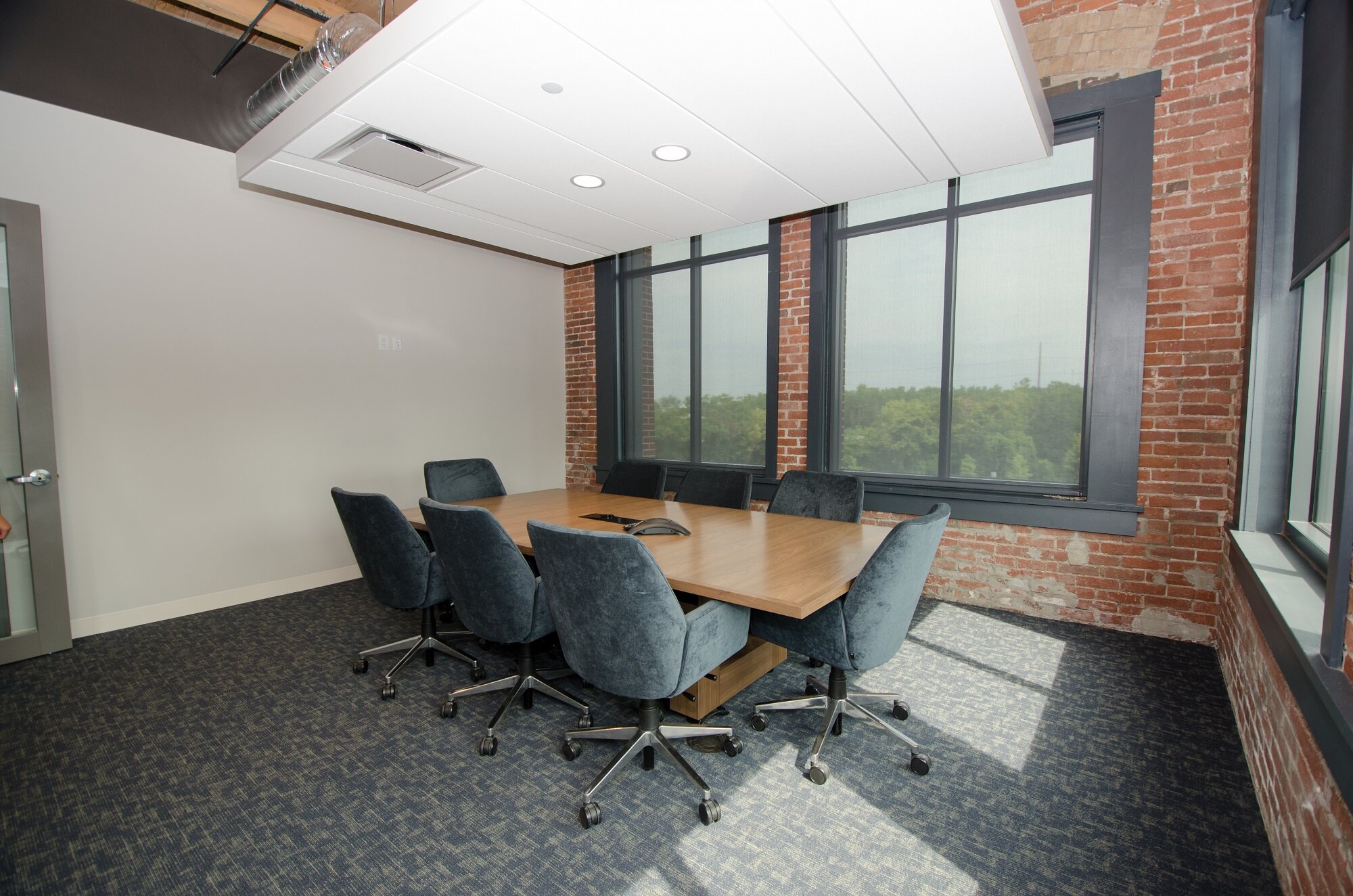 Not every meeting room at Plaskolite’s new headquarters featured A/V equipment on day one, but thanks to cost-effective design-stage planning, every space has the power and network connections (see the outlets on the white wall) to add them easily.