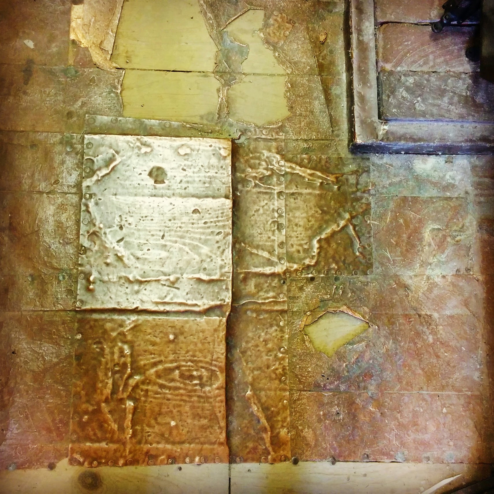 This is the floor of The Tool Barn, where it has been patched with copper. It looked so neat the way the copper had molded to the woodgrain over time.
