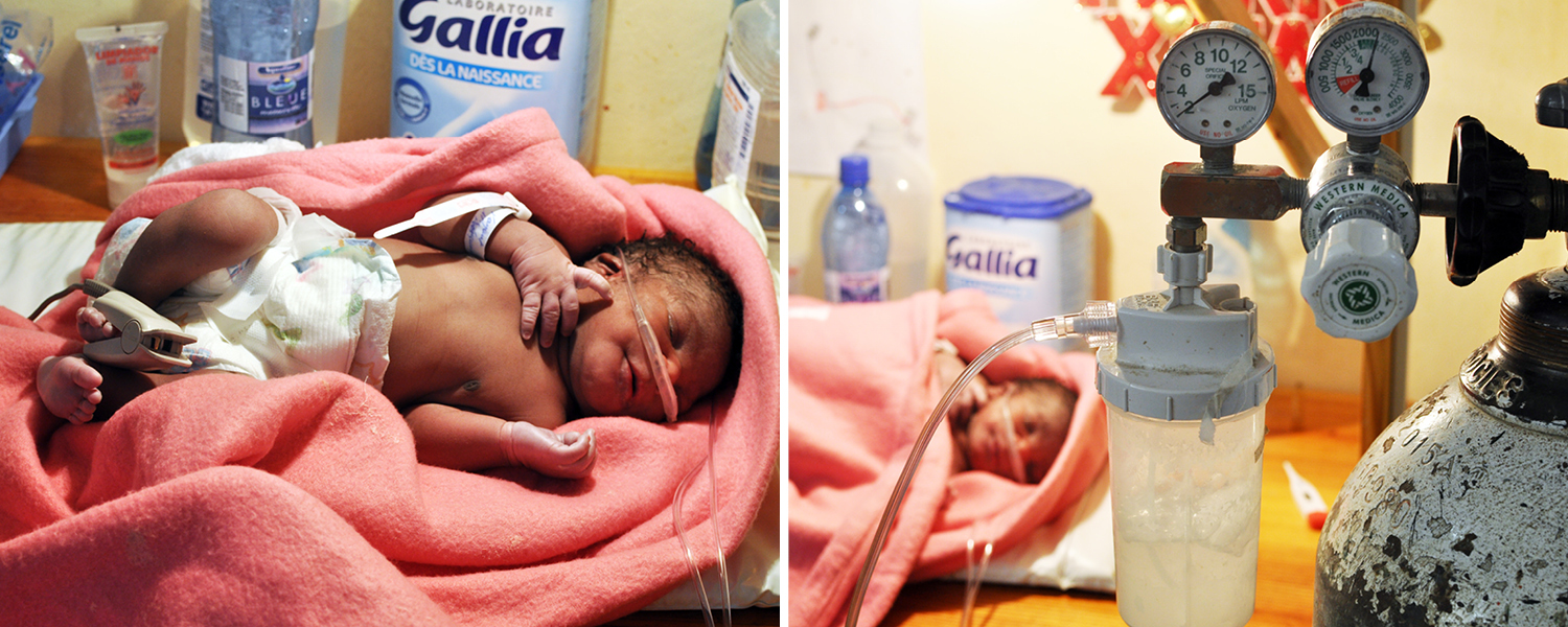 A newborn with pneumonia at Saint Boniface Hospital receives oxygen while blood oxygen is monitored through a clip on the foot.