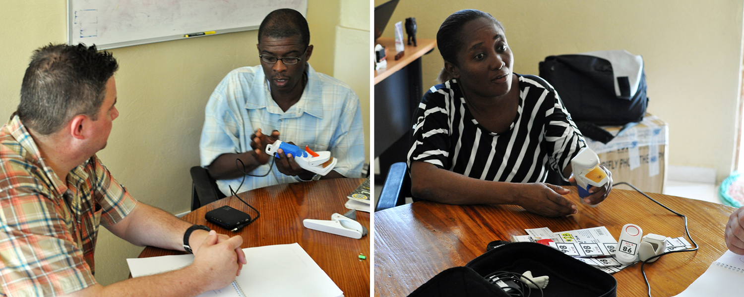 Tim asks Saint Boniface Hospital Director General Dr. Inobert Pierre (left) and Deputy Director Dr. Miliane Clermont (right) to try DtM’s Pelican pulse oximeter prototypes.