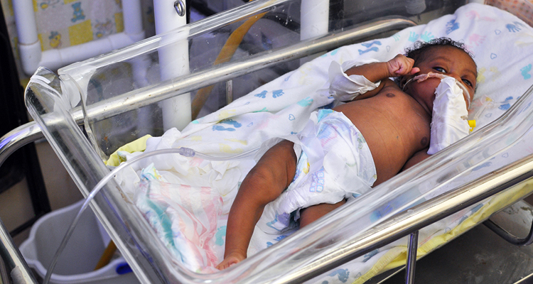 A newborn receiving IV fluids and oxygen at St Boniface Hospital in Haiti. 