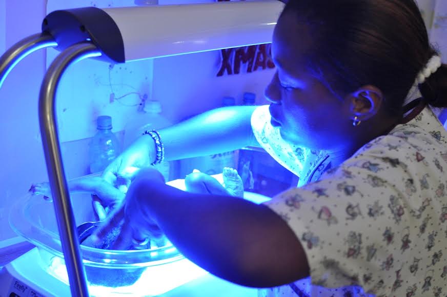 Ms Pascal Paul, a nurse in the St Boniface neonatal intensive care unit in Haiti, adjusts the eye mask of a newborn receiving phototherapy in Firefly.
