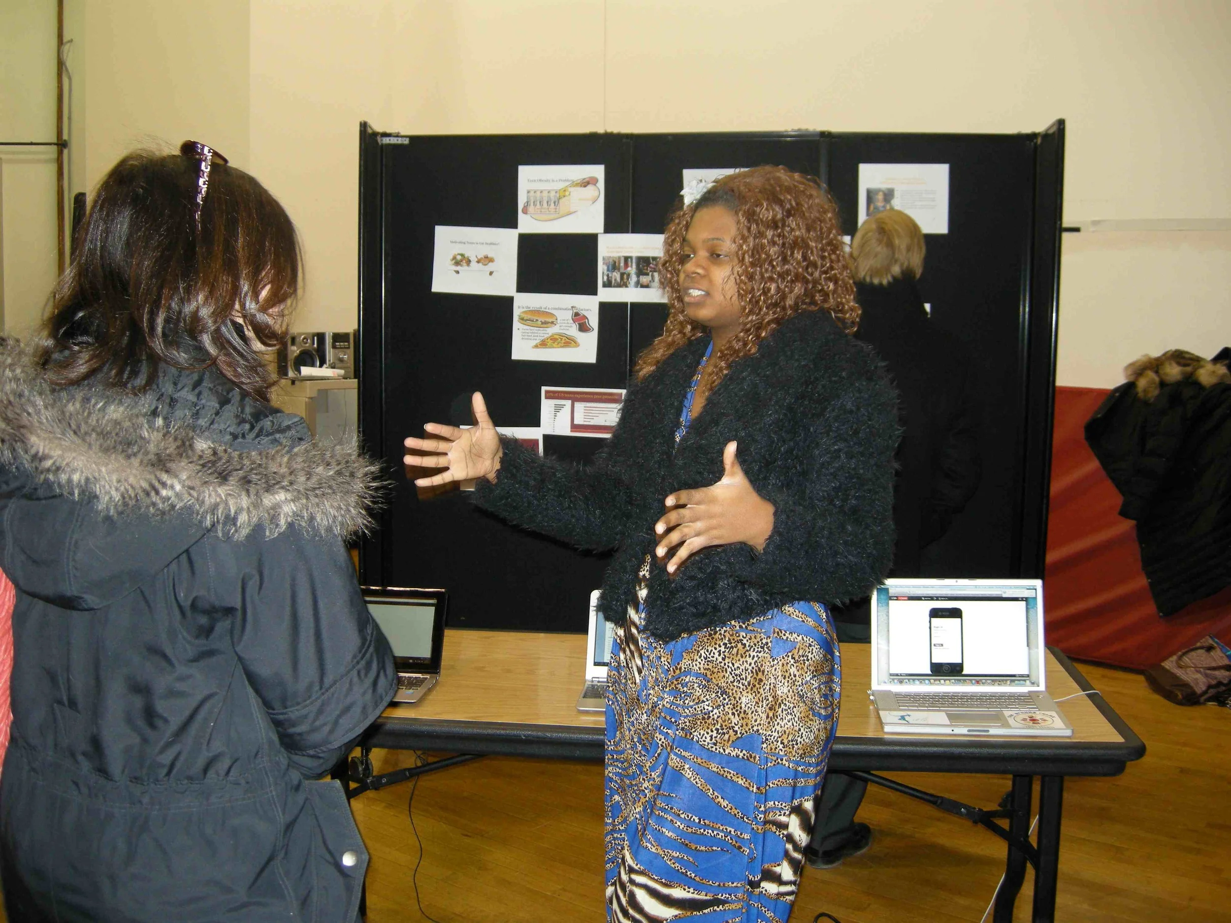 A student tells the story of her team's concept, during a showcase that ended the course.