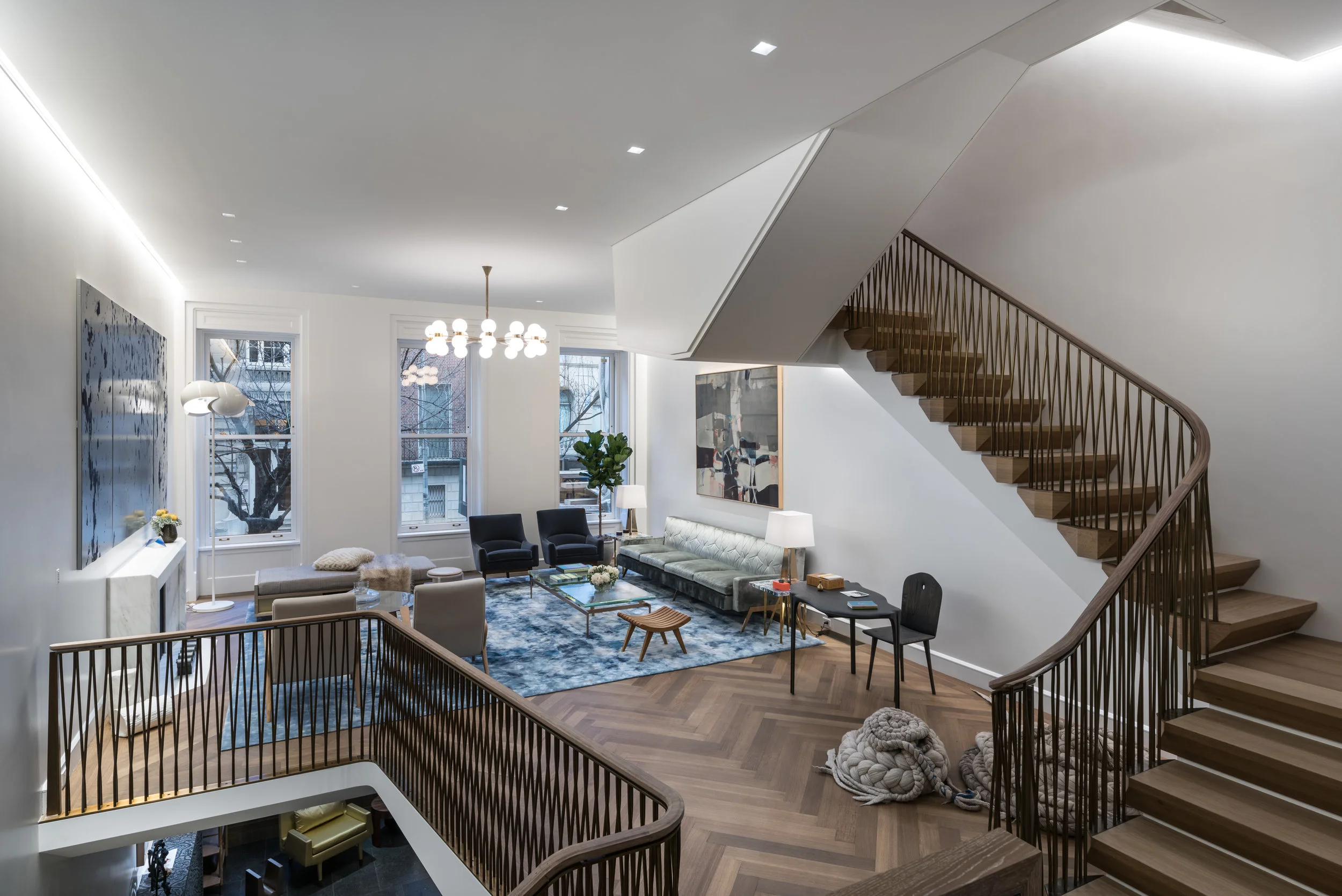 The main living room features continuous recessed wall slots that graze perimeter and highlight artwork. Recessed square aperture plaster-in accent lights highlight furniture groupings and artwork.