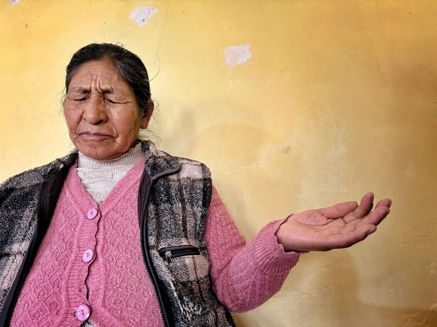 Woman praying at a local church &mdash; Andes, Peru