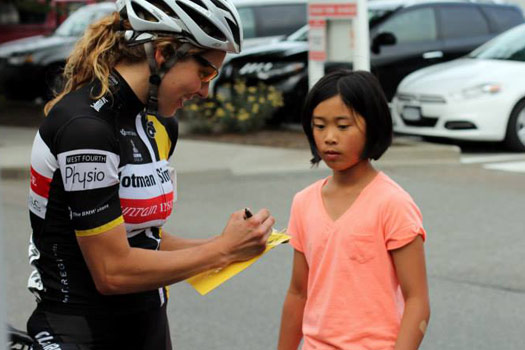 Alison signs her autograph for a future bicycle racer.