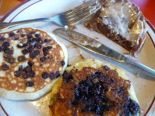 (Clock wise from top: Gingerbread pancakes with homemade maple spread, blueberry cornmeal, and chocolate chip plain pancakes.)