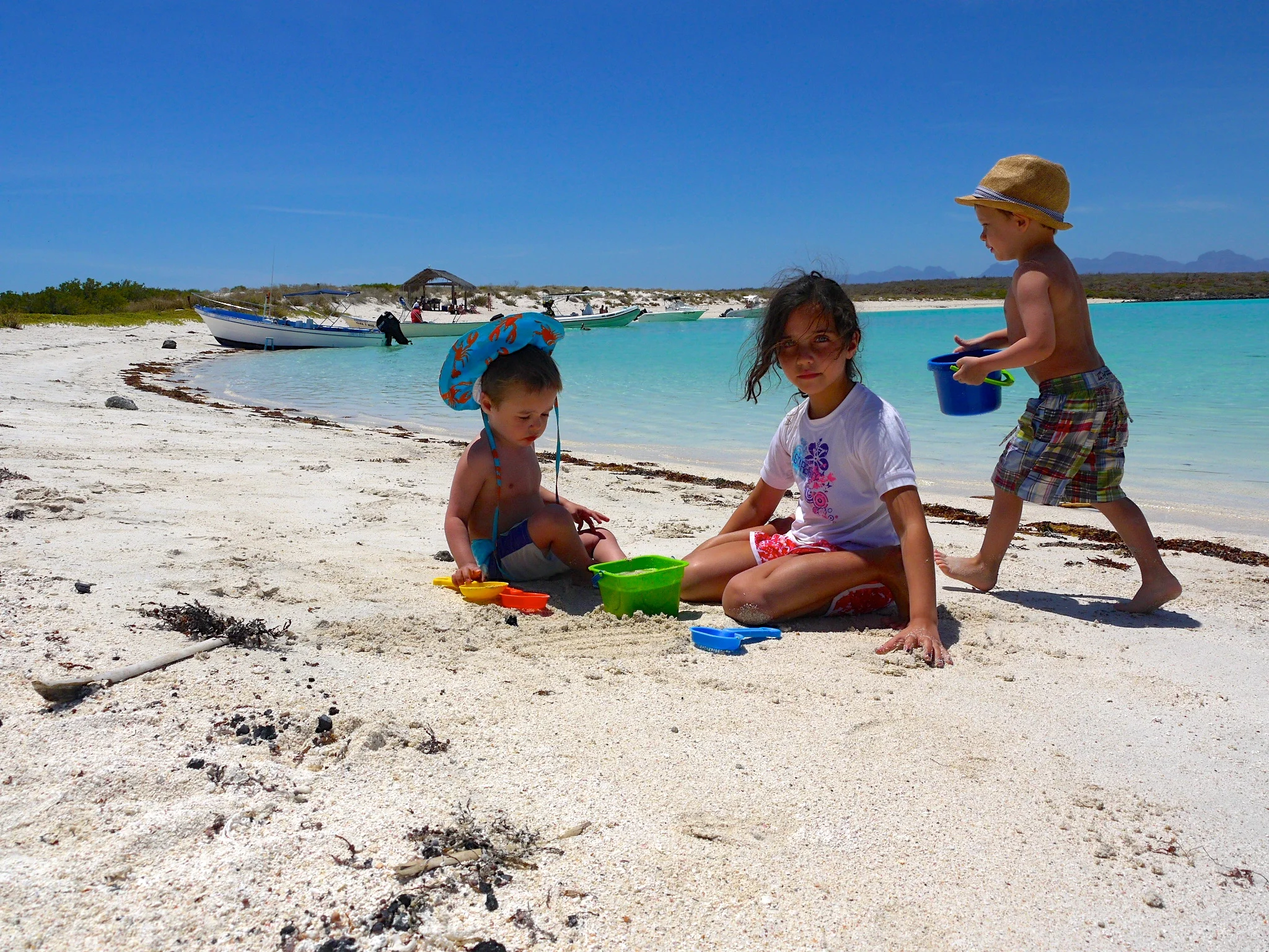Everett (and his goofy sun hat), Madeline, and Elliott hard at work building castles on Coronado Island.
