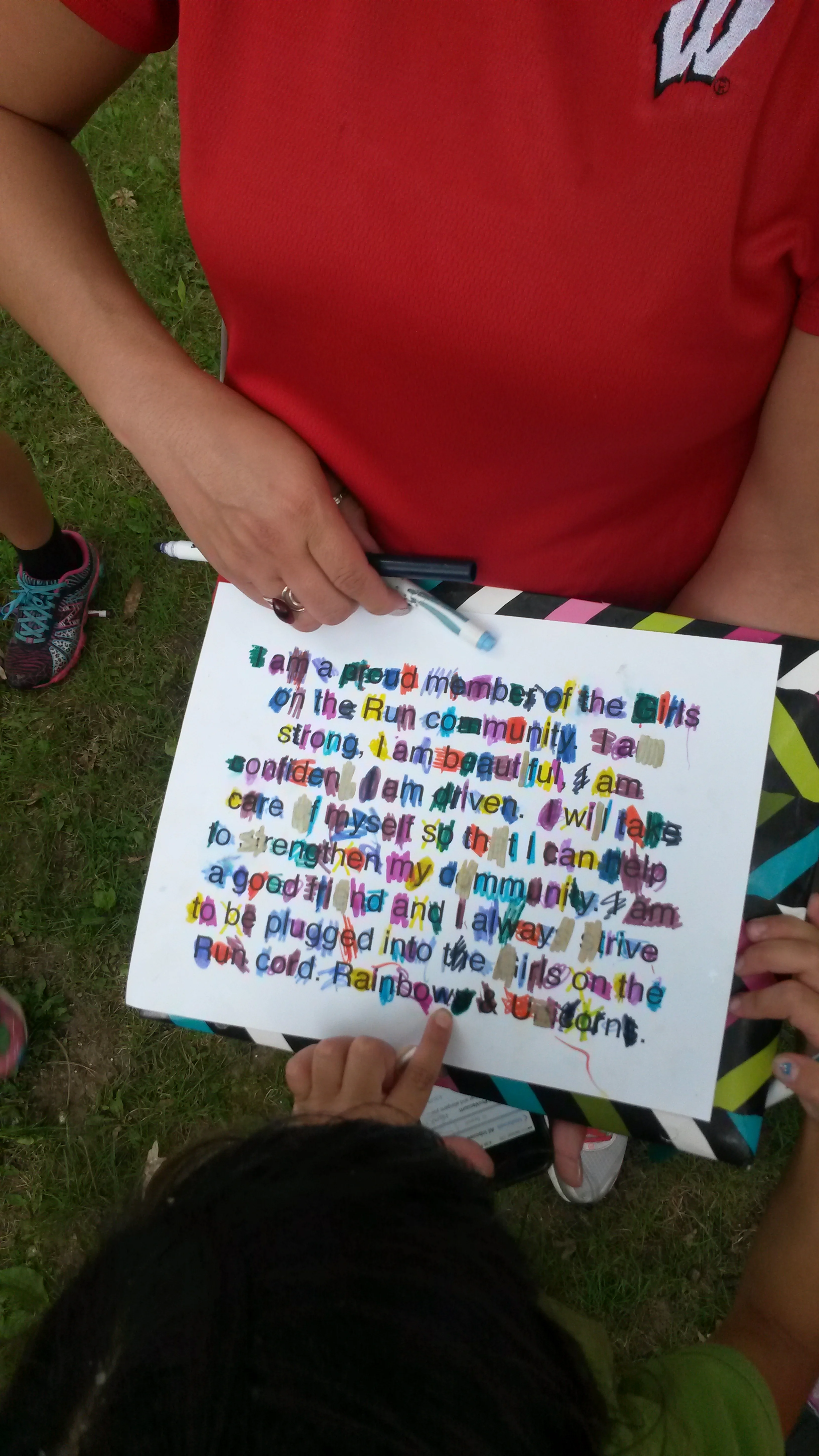 GIrls on the Run coach Meredith Rhodes Carson, a health coach with From This Day Forward Health Coaching, uses a message to help girls complete about 224 laps around a school yard. For every lap they completed they crossed off a letter in the statement. 